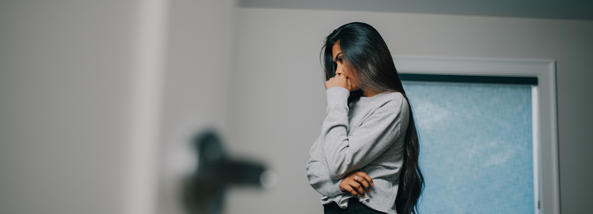 Woman individual in her space grappling with depression consequences.