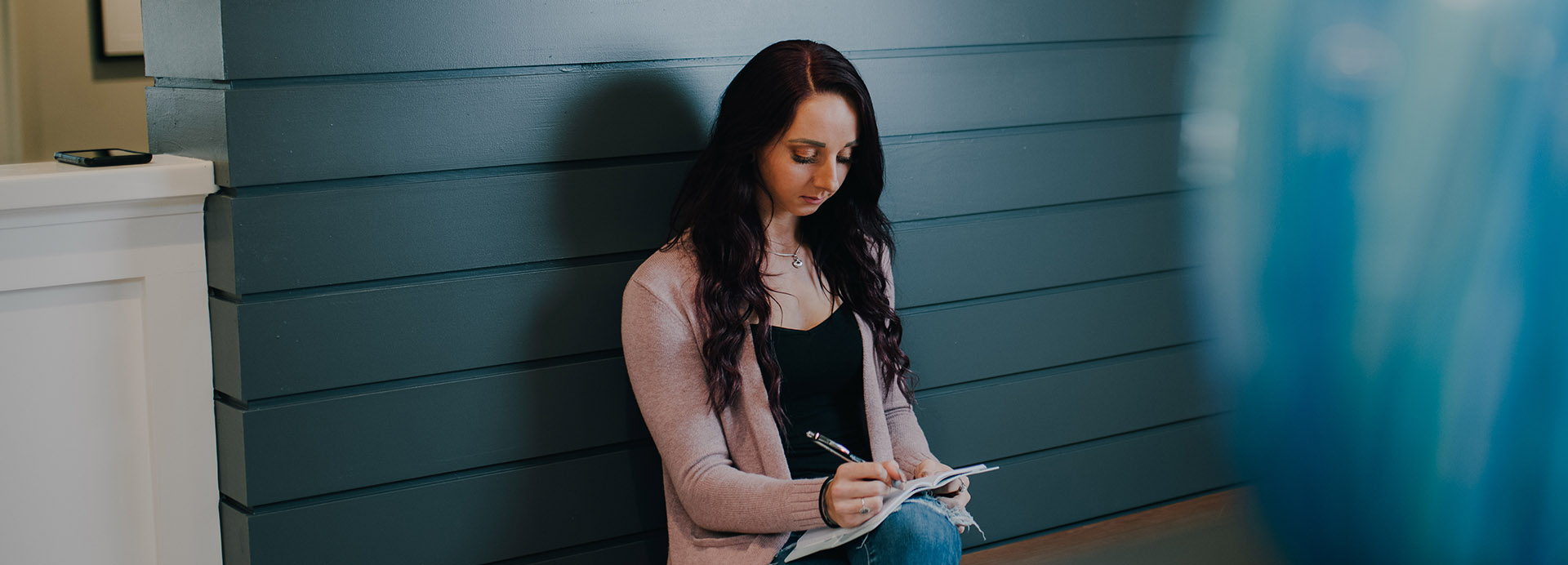 A patient writing in a journal dealing with PTSD and substance use New Jersey